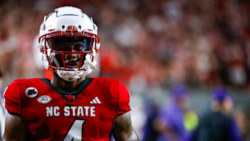 Aug 29, 2024; Raleigh, North Carolina, USA; North Carolina State Wolfpack wide receiver Dacari Collins (4) holds the football during the first half of the game against Western Carolina Catamounts at Carter-Finley Stadium. Mandatory Credit: Jaylynn Nash-Imagn Images