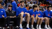 Florida Gators center Olivier Rioux sits on the bench against the Jacksonville Dolphins during an NCAA basketball game