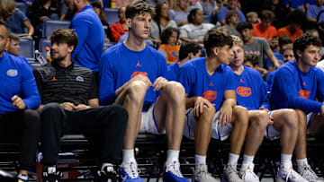 Florida Gators center Olivier Rioux sits on the bench against the Jacksonville Dolphins during an NCAA basketball game