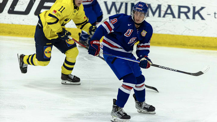 Aug 2, 2024; Plymouth, MI, USA; USA’s forward Chris Pelosi (20) follows the play in front of Sweden's forward Lucas Pettersson (11) during the second period of the 2024 World Junior Summer Showcase at USA Hockey Arena. Mandatory Credit: David Reginek-Imagn Images