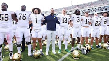 Sep 27, 2025; Fayetteville, Arkansas, USA; Notre Dame Fighting Irish head coach Marcus Freeman leads the team in celebration after the game against the Arkansas Razorbacks at Donald W. Reynolds Razorback Stadium. Notre Dame won 56-13. Mandatory Credit: Nelson Chenault-Imagn Images