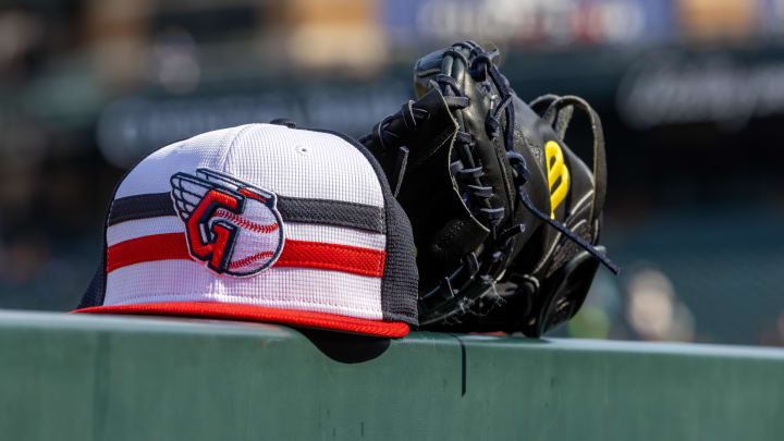 Jul 8, 2024; Detroit, Michigan, USA; A Cleveland Guardians baseball cap and glove sit on the dugout rail before the game against the Detroit Tigers at Comerica Park. Mandatory Credit: David Reginek-USA TODAY Sports