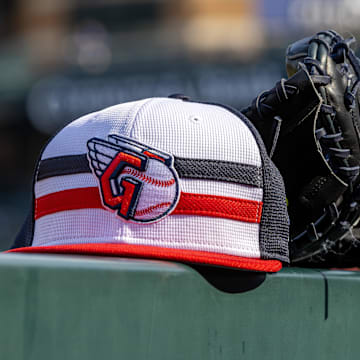 Jul 8, 2024; Detroit, Michigan, USA; A Cleveland Guardians baseball cap and glove sit on the dugout rail before the game against the Detroit Tigers at Comerica Park. Mandatory Credit: David Reginek-Imagn Images