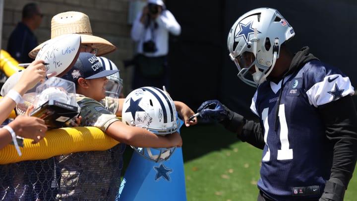 Jul 26, 2024; Oxnard, CA, USA; Dallas Cowboys linebacker Micah Parsons (11) signs autographs during training camp at the River Ridge Playing Fields in Oxnard, California.