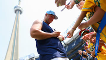 Ty France of the Toronto Blue Jays signs autographs for fans prior to Friday's game against the Kansas City Royals.