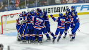 Aug 3, 2024; Plymouth, MI, USA; Team USA celebrates their O.T. shootout win over Canada during the of the 2024 World Junior Summer Showcase at USA Hockey Arena. Mandatory Credit: David Reginek-Imagn Images