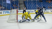Aug 3, 2024; Plymouth, MI, USA; Finland's forward Jesse Kiiskinen (23) pulls the puck between his legs and scores a goal on Sweden's goaltender Marcus Gidlof (1) during the third period of the 2024 World Junior Summer Showcase at USA Hockey Arena. Mandatory Credit: David Reginek-Imagn Images