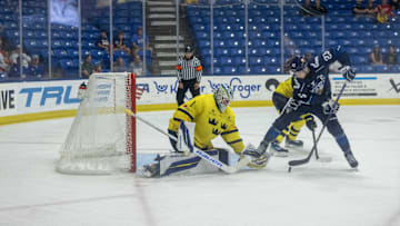 Aug 3, 2024; Plymouth, MI, USA; Finland's forward Jesse Kiiskinen (23) pulls the puck between his legs and scores a goal on Sweden's goaltender Marcus Gidlof (1) during the third period of the 2024 World Junior Summer Showcase at USA Hockey Arena. Mandatory Credit: David Reginek-Imagn Images