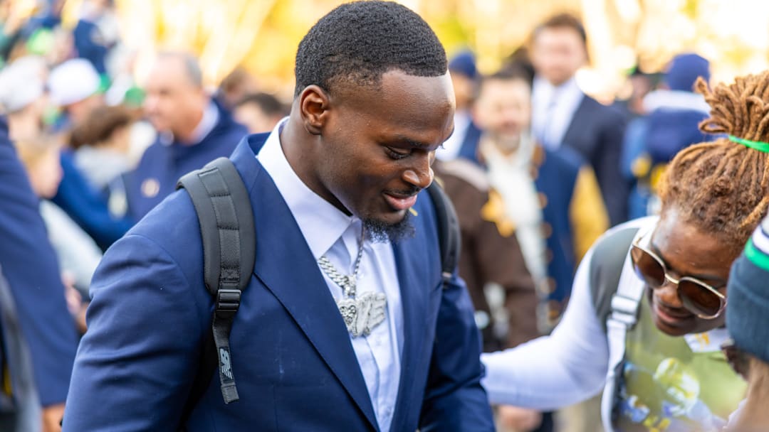 Nov 22, 2025; South Bend, Indiana, USA; Notre Dame Fighting Irish running back Jeremiyah Love greets fans while walking to the stadium before facing the Syracuse Orange at Notre Dame Stadium. Mandatory Credit: Michael Caterina-Imagn Images