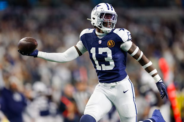 Dallas Cowboys linebacker DeMarvion Overshown intercepts a pass and returns it for a touchdown