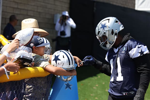 Dallas Cowboys linebacker Micah Parsons signs autographs during training camp at the River Ridge Playing Fields in Oxnard