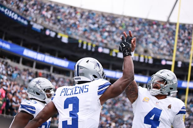 Dallas Cowboys wide receiver George Pickens celebrates with quarterback Dak Prescott.