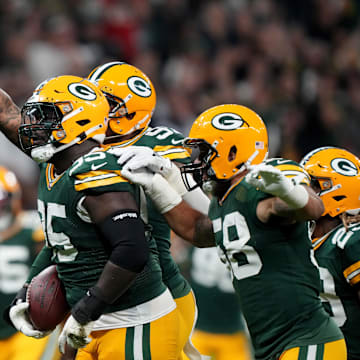 Green Bay Packers defensive tackle Devonte Wyatt (95) celebrates with teammates after recovering a fumble against the Eagles.