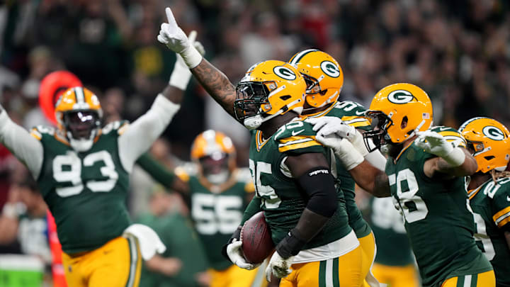 Green Bay Packers defensive tackle Devonte Wyatt (95) celebrates with teammates after recovering a fumble against the Eagles.