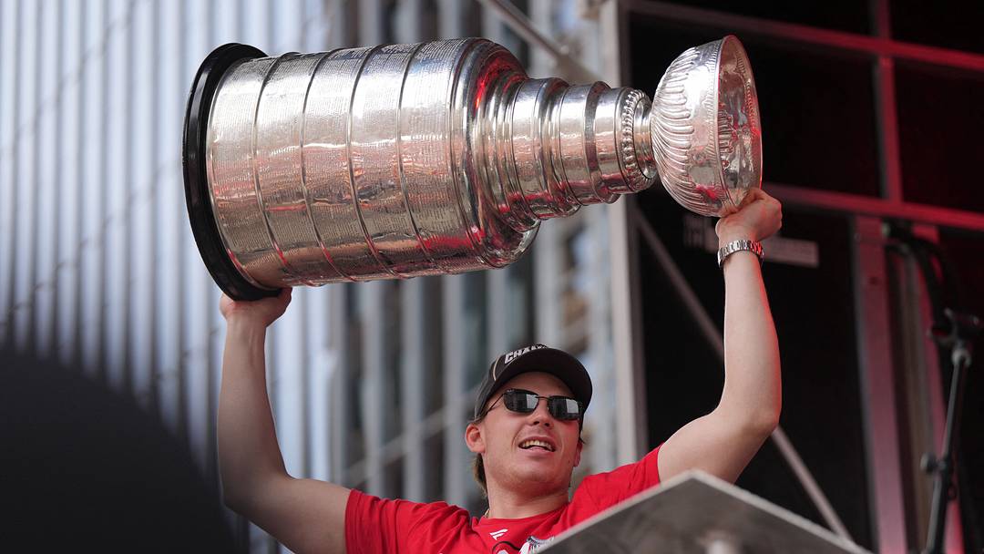 Jun 20, 2026; Raleigh, North Carolina, USA; Carolina Hurricanes defenseman Alexander Nikishin (21) holds up the Stanley Cup Trophy during the Stanley Cup championship parade and rally at Raleigh. Mandatory Credit: James Guillory-Imagn Images