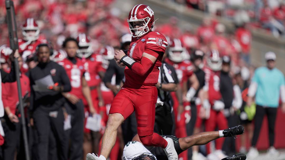 Wisconsin quarterback Colton Joseph (1) runs over Michigan State linebacker Caleb Wheatland (44) for a first down during the first quarter of their game Saturday, October 3, 2026 at Camp Randall Stadium in Madison, Wisconsin.