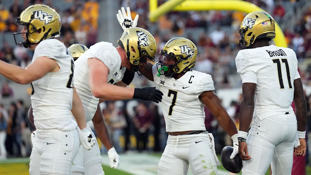 Nov 9, 2024; Tempe, Arizona, USA; UCF Knights running back RJ Harvey (7) celebrates a touchdown against the Arizona State Sun Devils during the first half at Mountain America Stadium, Home of the ASU Sun Devils. Mandatory Credit: Joe Camporeale-Imagn Images
