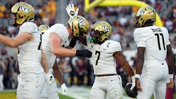 Nov 9, 2024; Tempe, Arizona, USA; UCF Knights running back RJ Harvey (7) celebrates a touchdown against the Arizona State Sun Devils during the first half at Mountain America Stadium, Home of the ASU Sun Devils. Mandatory Credit: Joe Camporeale-Imagn Images