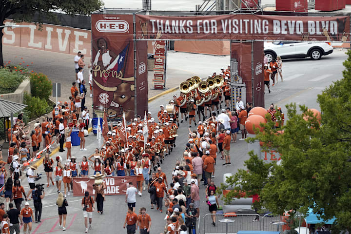 Texas Longhorns mascot Hook Em leads fans and cheerleaders in the Bevo Parade. 