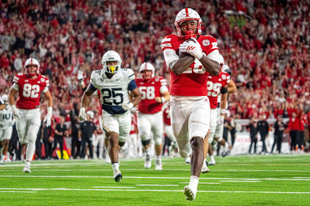 Nebraska Cornhuskers running back Kwinten Ives runs for a touchdown against the Akron Zips.