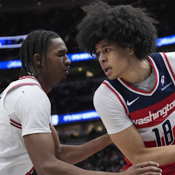 Apr 11, 2025; Chicago, Illinois, USA;Chicago Bulls forward Julian Phillips (15) defends Washington Wizards forward Kyshawn George (18) during the second half at United Center. Mandatory Credit: David Banks-Imagn Images