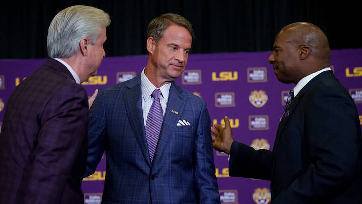 Dec 1, 2025; Baton Rouge, LA, USA; LSU president Wade Rousse, left, LSU new head coach Lane Kiffin, and LSU athletic director Verge Ausberry greet each other at South Stadium Club at Tiger Stadium. Mandatory Credit: Matthew Hinton-Imagn Images