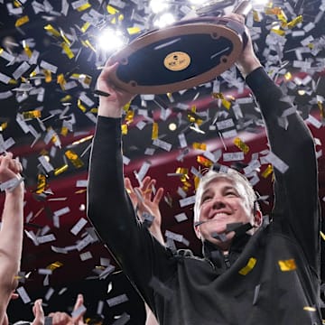 Purdue Boilermakers head coach Matt Painter holds up the NCAA midwest regionals trophy 