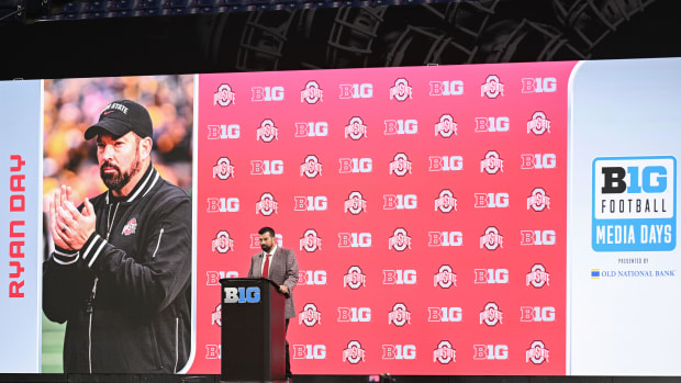 Head coach at podium during media day.