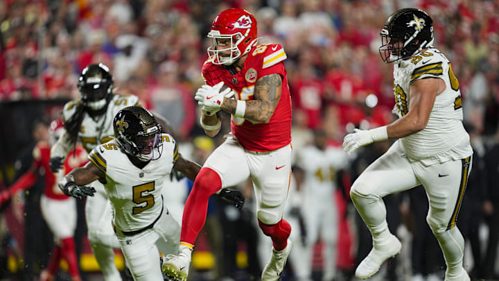 Oct 7, 2024; Kansas City, Missouri, USA; Kansas City Chiefs tight end Noah Gray (83) runs with the ball against New Orleans Saints cornerback Will Harris (5) and defensive tackle Bryan Bresee (90) during the first half at GEHA Field at Arrowhead Stadium. Mandatory Credit: Jay Biggerstaff-Imagn Images
