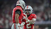 Dec 6, 2025; Indianapolis, IN, USA; Ohio State Buckeyes safety Caleb Downs (2) and cornerback Lorenzo Styles Jr. (3) react in the first half against the Indiana Hoosiers during the 2025 Big Ten championship game at Lucas Oil Stadium. Mandatory Credit: Aaron Doster-Imagn Images