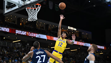 Oct 4, 2024; Palm Desert, California, USA; Los Angeles Lakers guard Max Christie (12) shoot against Minnesota Timberwolves center Rudy Gobert (27) during the first half at Acrisure Arena. Mandatory Credit: Jonathan Hui-Imagn Images