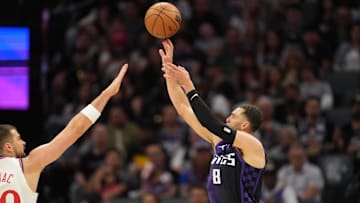 Apr 11, 2025; Sacramento, California, USA; Sacramento Kings guard Zach LaVine (8) shoots against Los Angeles Clippers center Ivica Zubac (left) during the third quarter at Golden 1 Center. Mandatory Credit: Darren Yamashita-Imagn Images