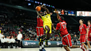 Nov 25, 2025; Las Vegas, Nevada, USA; Oregon Ducks forward Dezdrick Lindsay (4) drives the ball past San Diego State Aztecs forward Magoon Gwath (0) and guard Reese Dixon-Waters (39).
