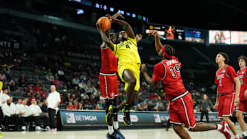 Nov 25, 2025; Las Vegas, Nevada, USA; Oregon Ducks forward Dezdrick Lindsay (4) drives the ball past San Diego State Aztecs forward Magoon Gwath (0) and guard Reese Dixon-Waters (39).