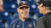 Virginia Cavaliers coach Brian O'Connor chats with the umpires prior to the game against the Florida Gators in the 2015 College World Series at TD Ameritrade Park. 