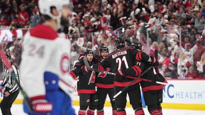 May 29, 2026; Raleigh, North Carolina, USA; Carolina Hurricanes center Logan Stankoven (22) (left) celebrates with teammates after scoring an even strength goal against Montreal Canadiens goaltender Jakub Dobes (not pictured) in game five of the Eastern Conference Final of the 2026 Stanley Cup Playoffs during the first period at Lenovo Center. Mandatory Credit: James Guillory-Imagn Images