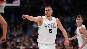 Mar 7, 2025; Denver, Colorado, USA; Denver Nuggets center Nikola Jokic (15) points in the second half against the Phoenix Suns at Ball Arena. Mandatory Credit: Ron Chenoy-Imagn Images