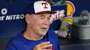 Texas Rangers manager Bruce Bochy (15) talks with the media in the dugout during batting practice before a game against the Toronto Blue Jays.
