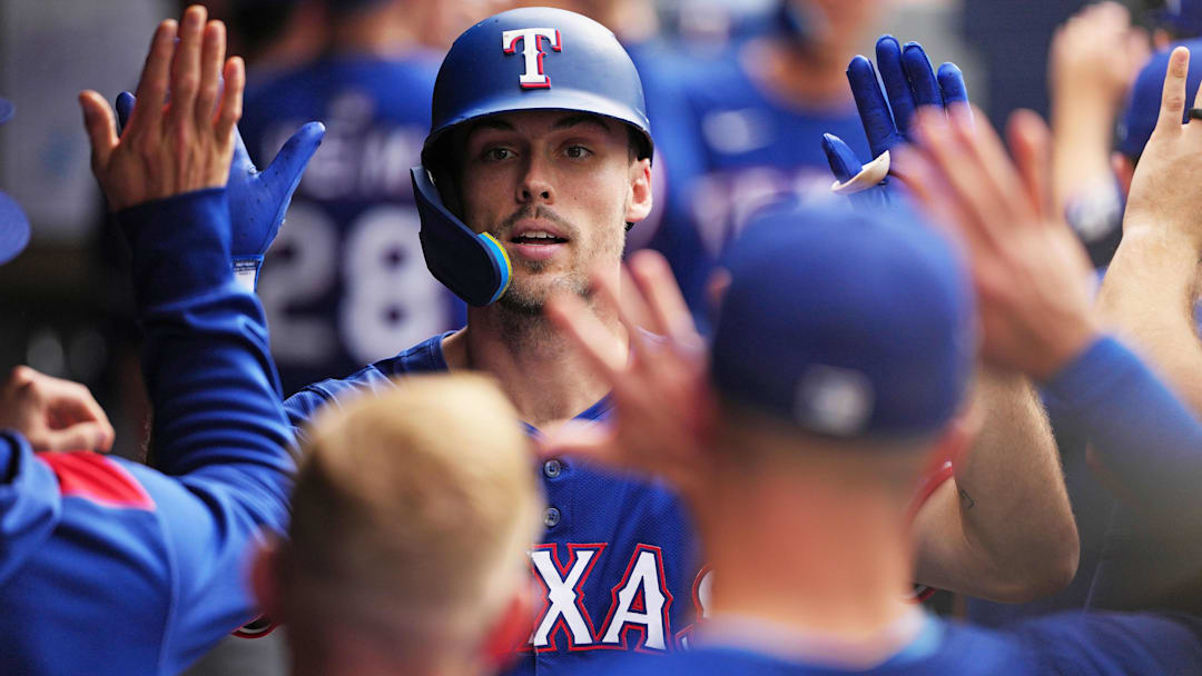 Texas Rangers centre fielder Evan Carter (32) celebrates in the dugout after hitting hits a two run home run against the Toronto Blue Jays during the ninth inn at Rogers Centre. 