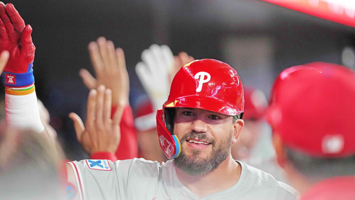 Philadelphia Phillies designated hitter Kyle Schwarber (12) hits a three-run home run and celebrates in the dugout against the Toronto Blue Jays during the ninth inning at Rogers Centre.