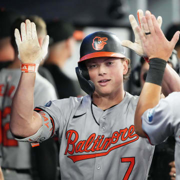 Aug 7, 2024; Toronto, Ontario, CAN; Baltimore Orioles second baseman Jackson Holliday (7) celebrates in the dugout after hitting a two run home run against the Toronto Blue Jays during the seventh inning at Rogers Centre.