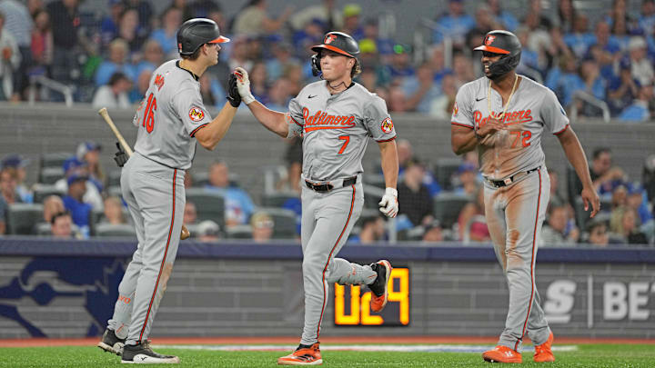 Aug 7, 2024; Toronto, Ontario, CAN; Baltimore Orioles second baseman Jackson Holliday (7) hits a two run home run and celebrates with  third baseman Coby Mayo (16) against the Toronto Blue Jays during the seventh inning at Rogers Centre. 