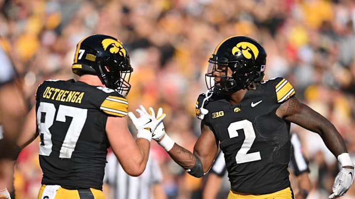 Sep 7, 2024; Iowa City, Iowa, USA; Iowa Hawkeyes tight end Addison Ostrenga (87) and running back Kaleb Johnson (2) react after a touchdown.