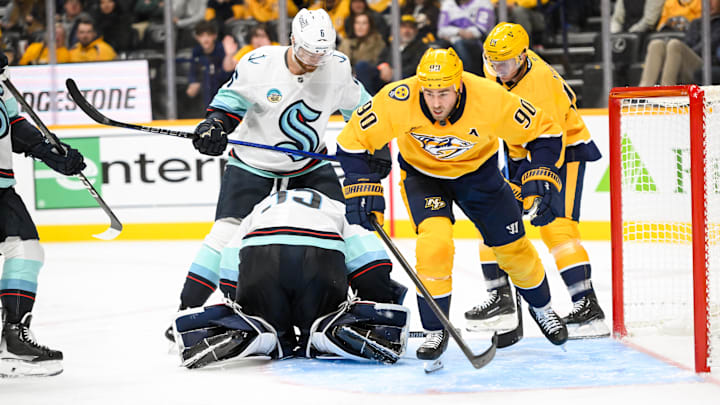 Oct 15, 2024; Nashville, Tennessee, USA; Seattle Kraken goaltender Joey Daccord (35) blocks the shot of Nashville Predators center Ryan O'Reilly (90)  during the third period at Bridgestone Arena. Mandatory Credit: Steve Roberts-Imagn Images