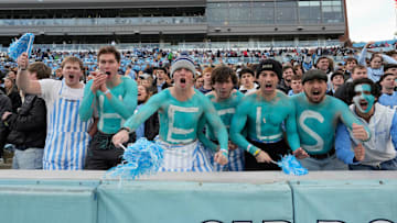 Nov 30, 2024; Chapel Hill, North Carolina, USA; North Carolina Tar Heels fans with Heels painted on their chest cheer in the first quarter at Kenan Memorial Stadium. Mandatory Credit: Bob Donnan-Imagn Images