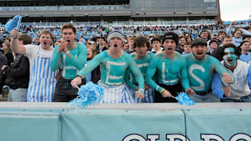 Nov 30, 2024; Chapel Hill, North Carolina, USA; North Carolina Tar Heels fans with Heels painted on their chest cheer in the first quarter at Kenan Memorial Stadium. Mandatory Credit: Bob Donnan-Imagn Images