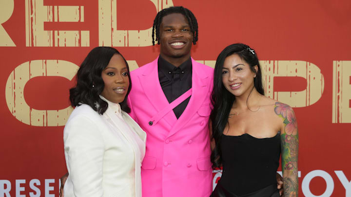 Colorado Buffaloes wide receiver Travis Hunter with his mother Ferrante Harris and his fiancee Leanna Lenee on the red carpet before the 2025 NFL Draft at Lambeau Field. 