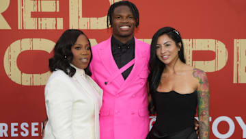 Colorado Buffaloes wide receiver Travis Hunter with his mother Ferrante Harris and his then fiancee Leanna Lenee on the red carpet before the 2025 NFL Draft at Lambeau Field.