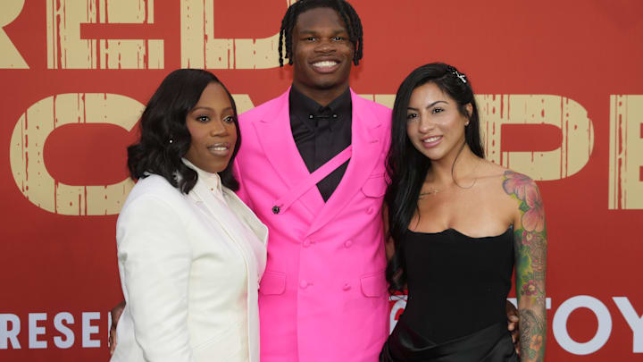 Colorado Buffaloes wide receiver Travis Hunter with his mother Ferrante Harris and his fiancee Leanna Lenee on the red carpet before the 2025 NFL Draft at Lambeau Field.