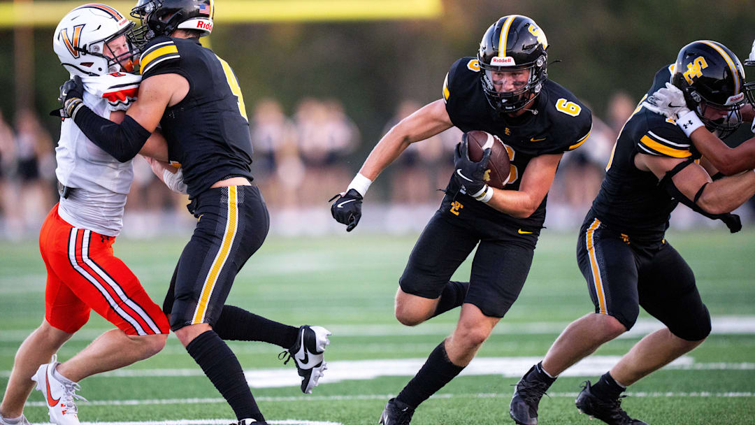 Southeast Polk's Sam Zelenovich (6) carries the ball for a gain of yards against Valley on Friday, Aug. 30, 2024, at Southeast Polk Stadium.